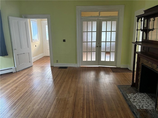 living room with french doors, a high end fireplace, and dark hardwood / wood-style floors