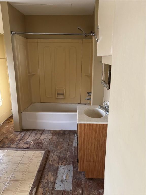 bathroom featuring hardwood / wood-style floors, vanity, and tub / shower combination