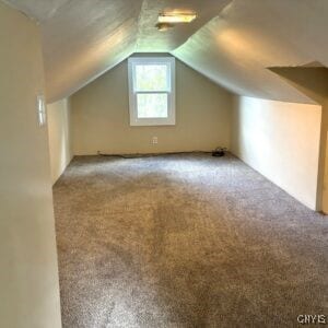 bonus room with carpet floors and vaulted ceiling