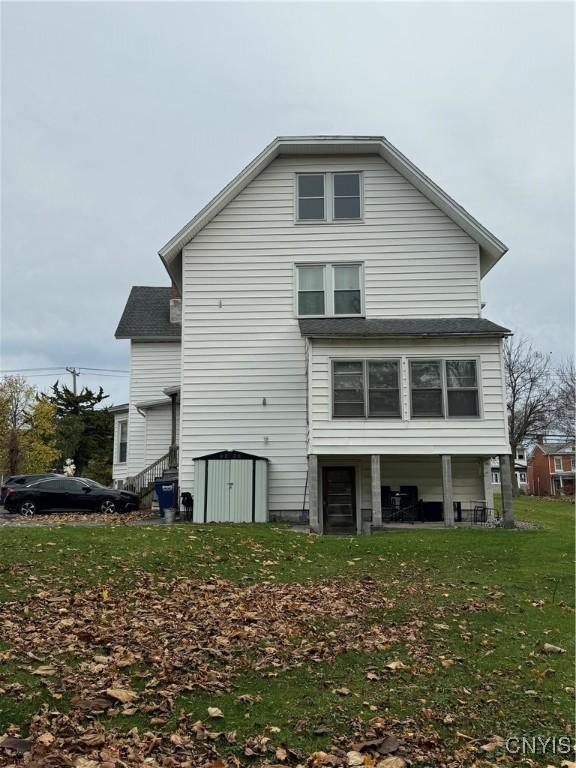 rear view of property with a yard