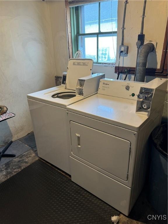 washroom featuring washing machine and clothes dryer and laundry area