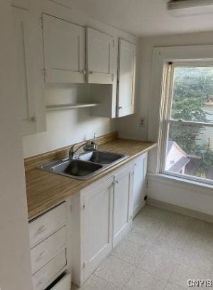 kitchen featuring sink and white cabinets