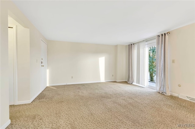 spare room featuring light colored carpet