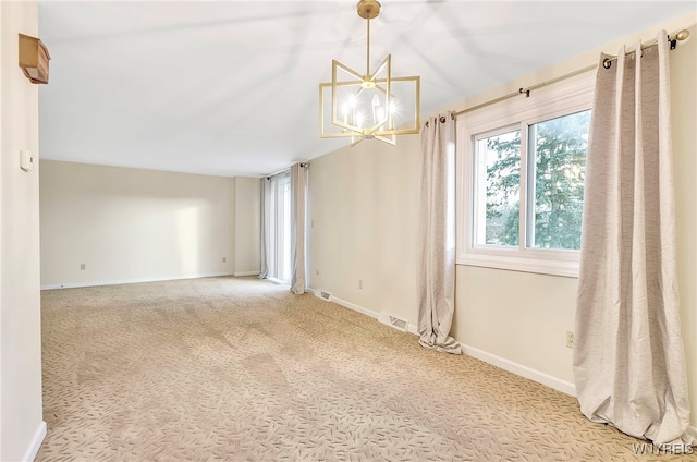 unfurnished room with carpet flooring and a notable chandelier