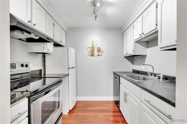 kitchen with sink, white cabinetry, stainless steel appliances, and light hardwood / wood-style flooring