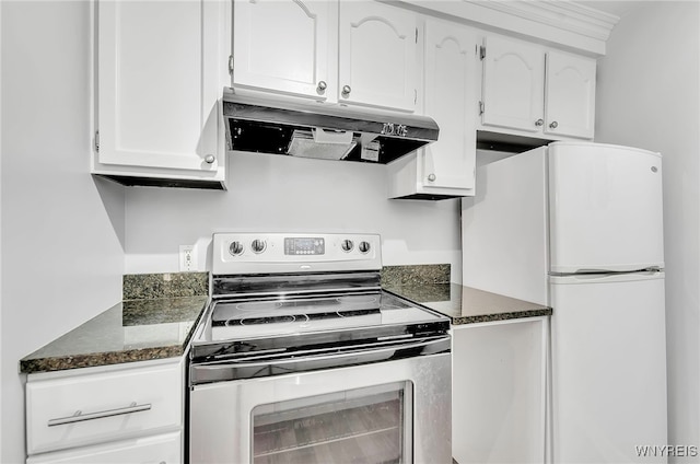 kitchen with white refrigerator, white cabinetry, stainless steel range with electric stovetop, and dark stone counters