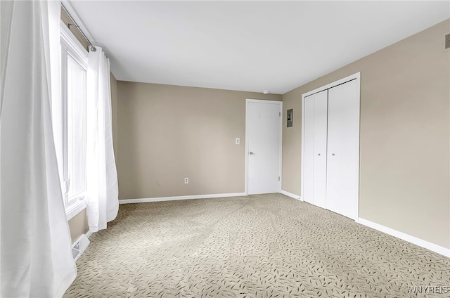 unfurnished bedroom with carpet flooring and a closet