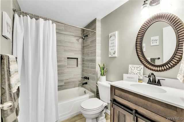 full bathroom with hardwood / wood-style floors, vanity, toilet, and shower / bath combo with shower curtain