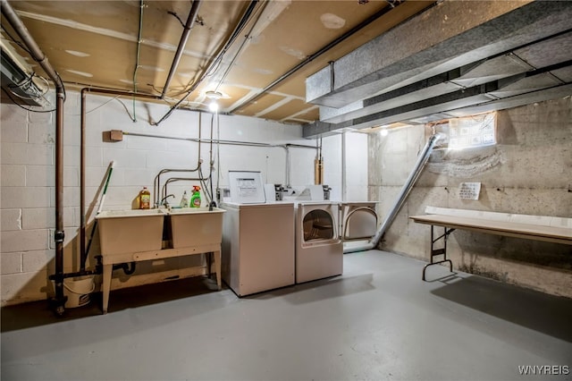 basement with sink and washing machine and clothes dryer