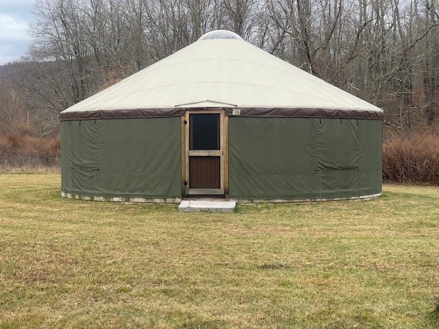 view of outbuilding featuring a lawn