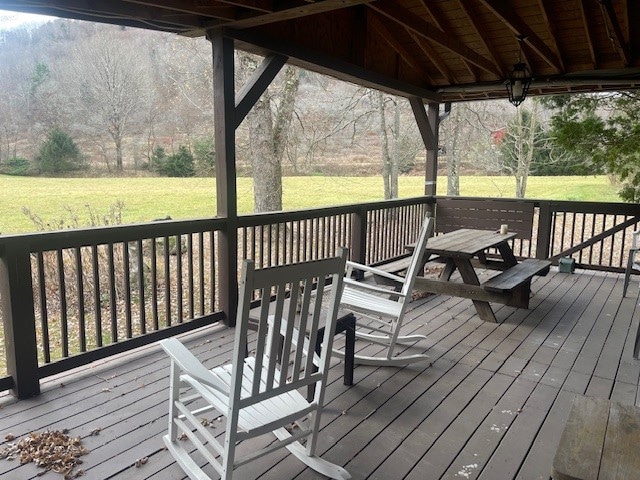 deck featuring a gazebo and a yard