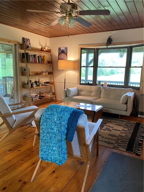 living room featuring light hardwood / wood-style flooring, ceiling fan, and wooden ceiling