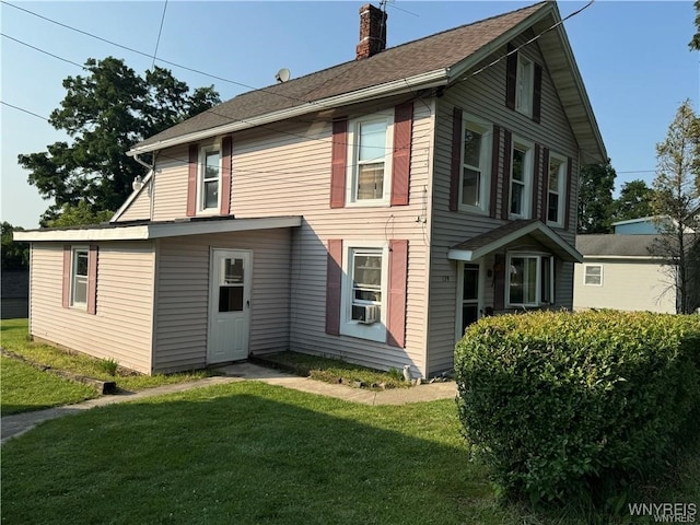 back of property featuring a lawn and cooling unit