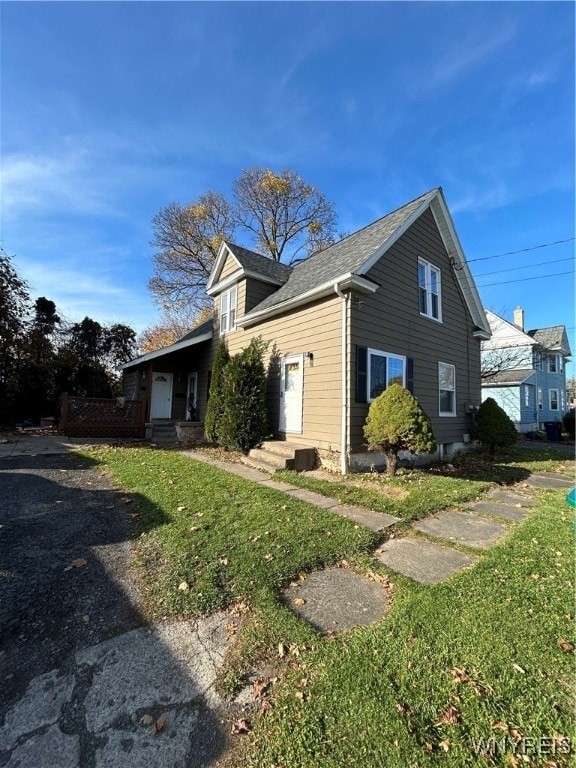 view of side of home with a lawn