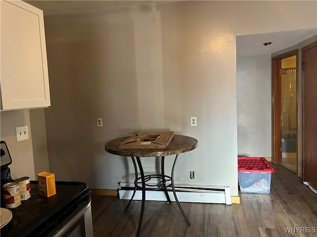 dining room featuring baseboard heating and dark wood-type flooring