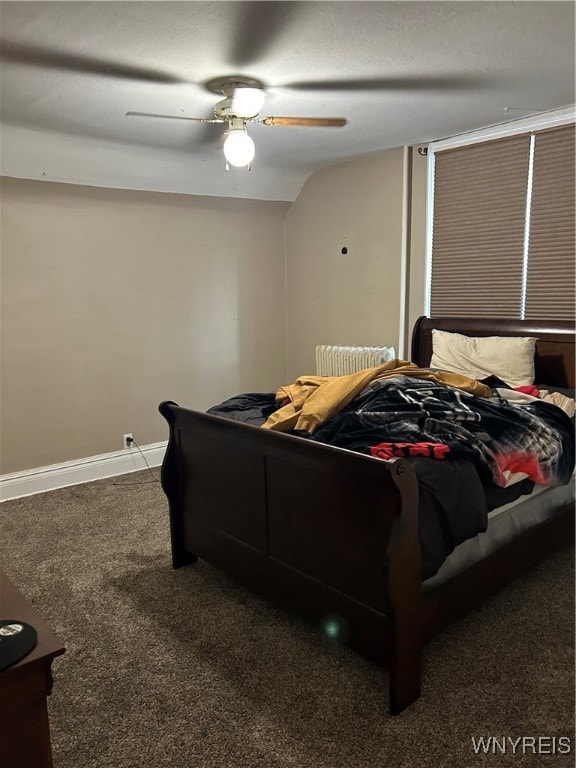 carpeted bedroom featuring ceiling fan, a textured ceiling, and vaulted ceiling