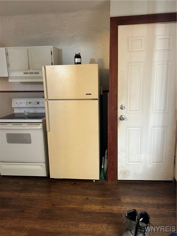 kitchen featuring white cabinetry, dark hardwood / wood-style flooring, and white appliances