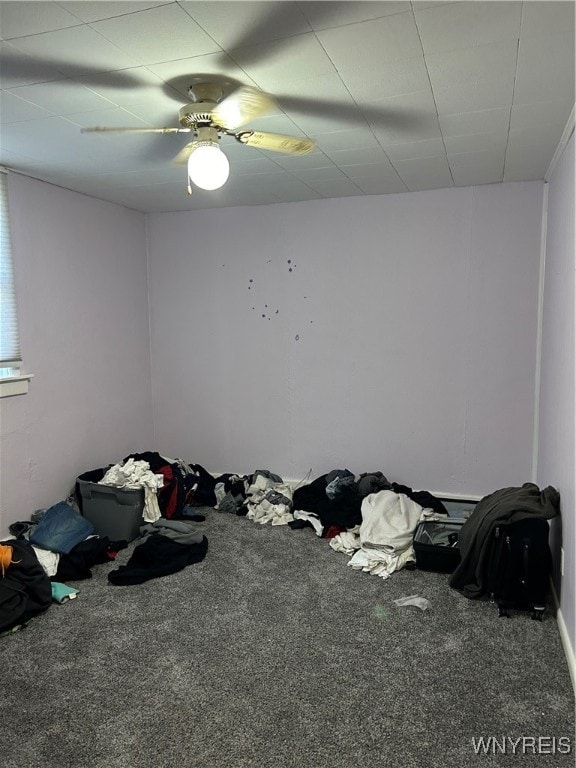 unfurnished bedroom featuring ceiling fan and carpet