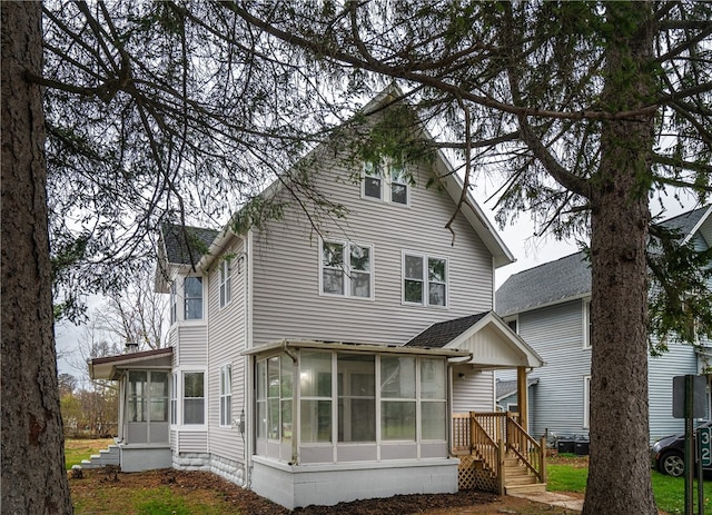 rear view of property with a sunroom