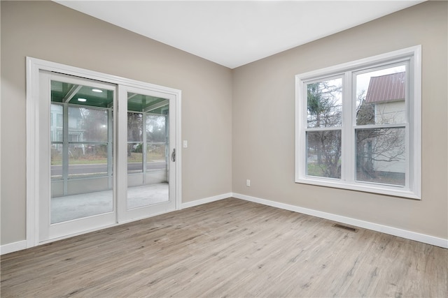 unfurnished room with light hardwood / wood-style floors