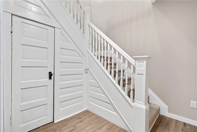 stairway featuring wood-type flooring