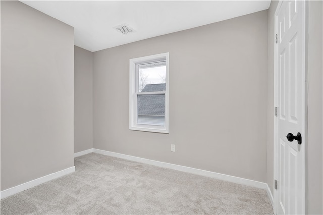 unfurnished room featuring light carpet