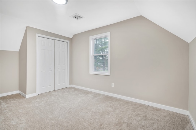 bonus room with light carpet and lofted ceiling