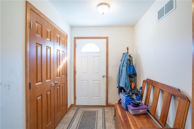 foyer entrance featuring visible vents