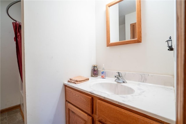 bathroom featuring curtained shower and vanity