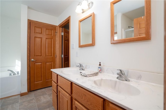 bathroom featuring a garden tub, double vanity, and a sink