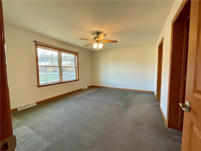 carpeted empty room featuring ceiling fan, visible vents, and baseboards