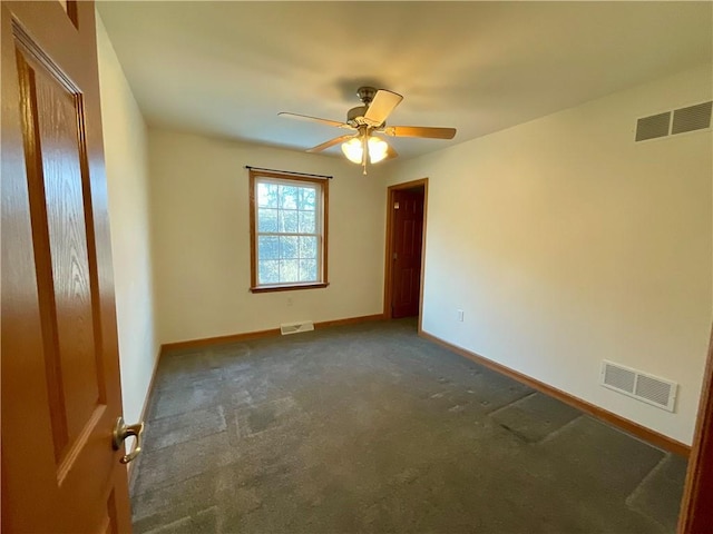 carpeted spare room featuring visible vents, ceiling fan, and baseboards