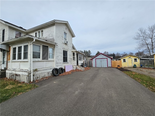 view of property exterior featuring a garage and a storage shed