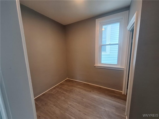 spare room featuring wood finished floors