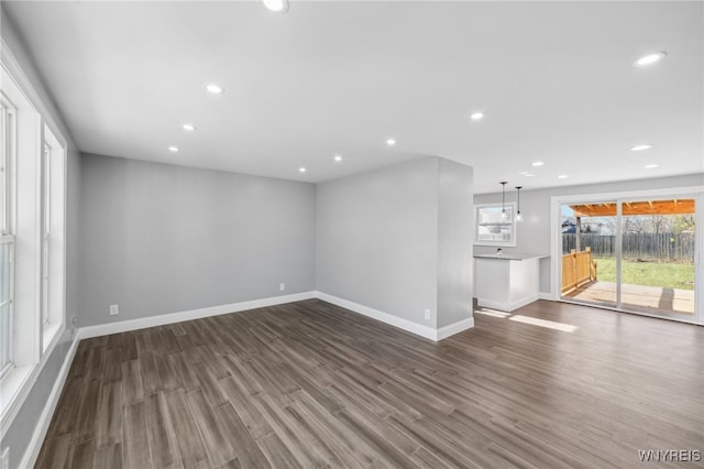 unfurnished living room featuring dark hardwood / wood-style flooring