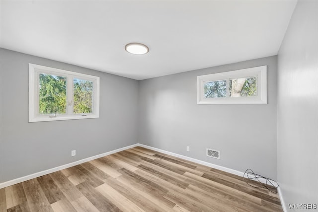 unfurnished room with light hardwood / wood-style flooring