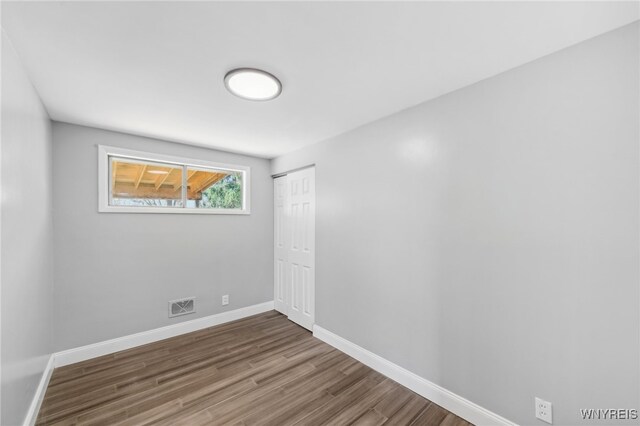 unfurnished room with hardwood / wood-style floors