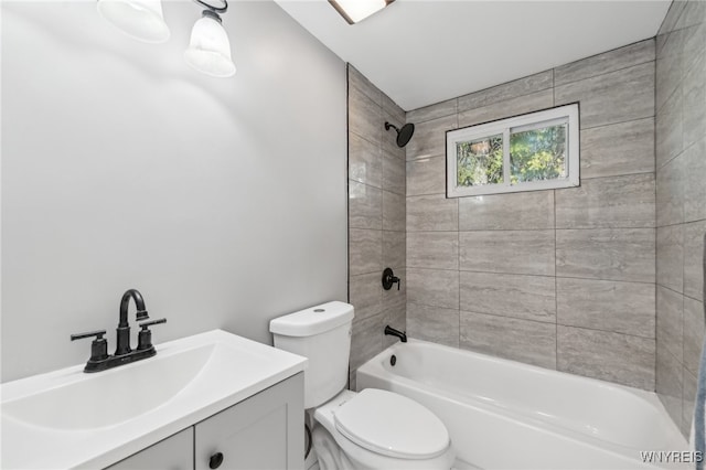 full bathroom featuring vanity, toilet, and tiled shower / bath