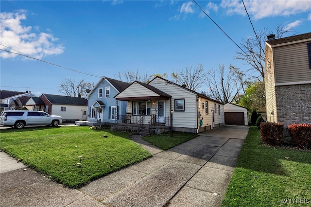 bungalow-style house with a garage, covered porch, an outbuilding, and a front lawn