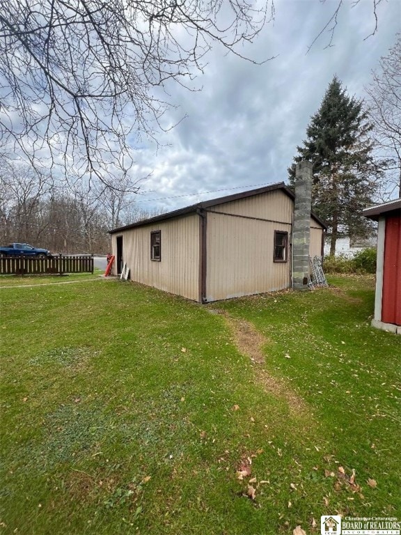 view of outbuilding with a yard