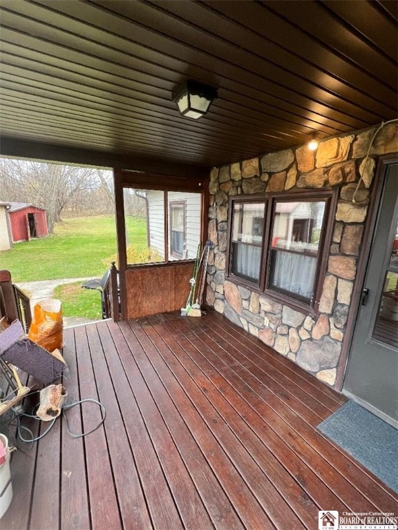 wooden deck featuring a yard