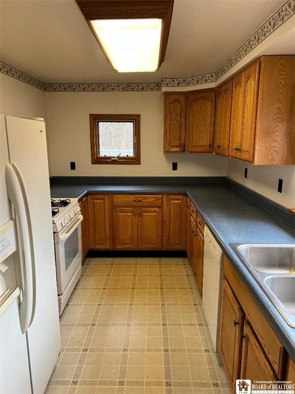 kitchen featuring white appliances and sink