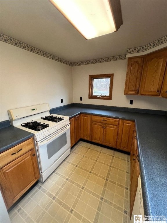 kitchen with white range with gas stovetop