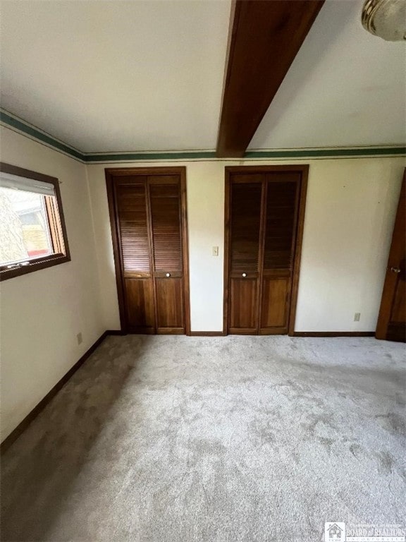 unfurnished bedroom with light colored carpet