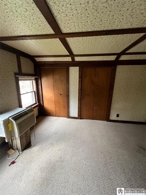 unfurnished bedroom with carpet and coffered ceiling