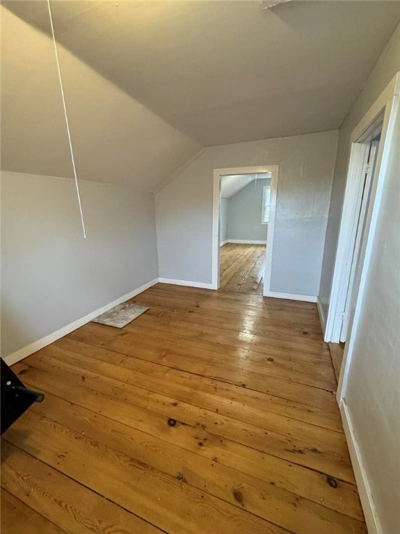 bonus room with wood-type flooring and lofted ceiling
