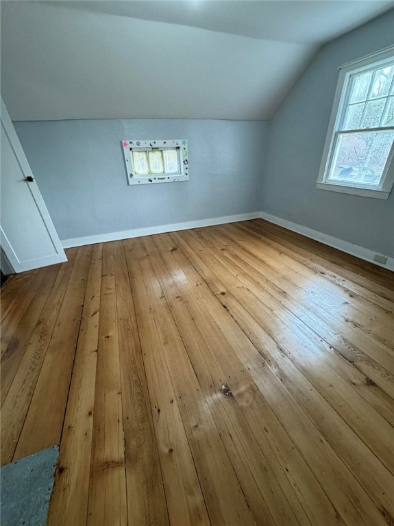 bonus room featuring hardwood / wood-style flooring and lofted ceiling
