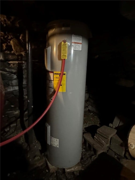 utility room featuring electric water heater