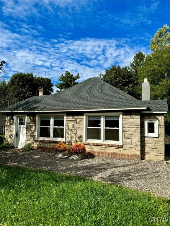 view of side of home featuring a lawn