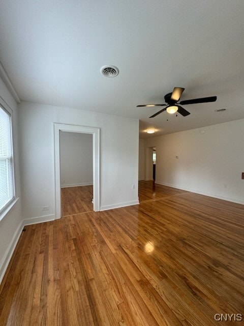 empty room featuring wood-type flooring and ceiling fan